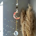 Detail of suncatcher prism throwing rainbow light spots with amethyst beads and crystals - Watermelon red
