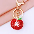 Golden apple keychain with red rhinestones and white deer motif for bags - Safe Deer Apple