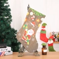 Detailed view of a Christmas stocking with Santa motif on a vintage Eiffel Tower stand - Brown Santa Candy Cane Style