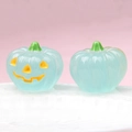 Detailed view of luminous blue glass pumpkins with glowing yellow jack-o'-lantern faces - Luminous Light Blue (Yellow Expression)