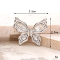 Macro shot of silver bow charm with clear crystals on stone, size 3.5cm by 2.9cm - D2744 White K Small Butterfly White