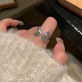 Silver bow butterfly open ring with textured wings worn on a cozy white knit sweater - Butterfly Open Style (J4230)