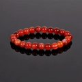 8mm natural red agate bead bracelet with polished white banding on black reflective surface - Red Stripe Agate