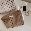Detailed macro view of polka dot corduroy cosmetic bags with zipper and logo label - Brown Polka Dot