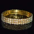Detailed macro view of the three-row rhinestone crystal arrangement on a gold bridal bracelet - 3 Row Gold Clear Rhinestone Bracelet