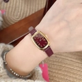 Elegant gold rectangular watch with burgundy leather strap and Roman numerals on wrist - Square Roman Numerals