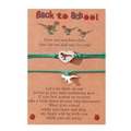 Detail showing two silver dinosaur bracelets with green ropes on a Back to School card - Green Cord (B00447) / Set of 2