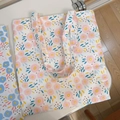 Close-up of printed floral canvas tote bags showing textured fabric and dual shoulder straps - T-24 White Background with Pink Small Circles