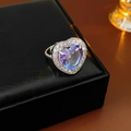 Macro shot of heart-shaped gradient zircon ring with micro-pave setting on a leather box - Heart Halo Style / Purple