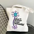 White canvas tote bag featuring a colorful neuron illustration and motivational slogan - C13 Potential Neuron No Inner Pocket No Zipper