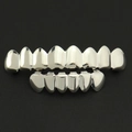 Hip hop silver color teeth grillz set with upper and lower metal caps on leather background - 14-Piece Set / Top 8 Bottom 6 Silver Set