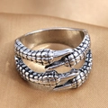 Vintage silver wrap ring with detailed wing textures on elegant satin background - Silver Scale Texture