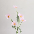 Macro detail of artificial pink daisies with yellow centers and realistic green leaves - Pink