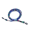 Close-up of ethnic style woven eyeglass strap with blue patterns and rubber loops - Style 8/Blue Mixed