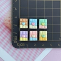 Miniature resin chocolate charms with heart accents measured on a scale mat - Chocolate Mixed Colors