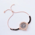 Detail of rose gold bracelet watch with rhinestone bezel and adjustable heart charm slider - Rose Gold-Round Black Dial (Fadi)