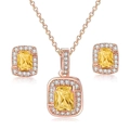 Detail of rose gold jewelry set with emerald-cut yellow gemstones and halo diamonds - Rose Gold + Yellow Stone Set