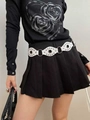 White Y2K punk style leather belt with metal studs and rings worn over a black skirt - White