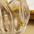 Elegante collana in acciaio inossidabile dorato con doppi pendenti a loto su un vetro - Piccolo / Oro