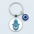 Silver metal keychain with Hamsa Hand and blue Evil Eye charm on a grey background - Hamsa Hand
