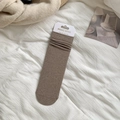 Dark brown combed cotton mid-tube slouch socks with minimalist packaging on white fabric - One Size / Light Brown