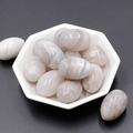 Polished grey striped natural agate egg stone displayed in a white ceramic dish - White Crazy Agate (1pc)