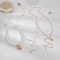 3-piece gold shell and cross pearl necklace set displayed with sea shells on beach sand - Gold (3-Piece Set)