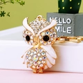 Sparkling owl keychain with white enamel and AB crystals on a golden metal frame - A430 Owl O White