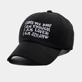 Detail view of white embroidered text on a black cotton baseball cap with a curved brim - Adjustable / Black