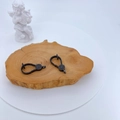 Micro-paved black zircon clasp connector on a wooden plate with an angel statue - Black