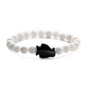Detailed close-up of beaded bracelet with white beads and black blue sand fish charm - Blue Sandstone Porcelain White Penguin