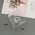 Transparent PVC storage pouch with white pearl hoop earrings, measuring 8cm x 8cm size - 30 Silk 8*8cm (100 Pcs)