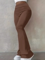 Detail of brown high-waisted flared leggings paired with white platform sneakers - Brown