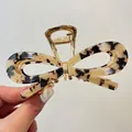 Detail of tortoiseshell acetate bow hair claw clip with golden metal spring mechanism - 11.5cm Claw Clip / Beige Tortoise Shell