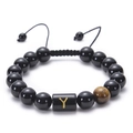 Detailed macro of black onyx bead bracelet featuring adjustable cord and gold Y letter charm - Letter Y
