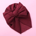 Detailed view of a soft burgundy baby turban hat featuring a large double bow decoration - Burgundy