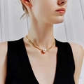Elegant gold snake chain necklace with pearl pendant on a model neck for women - Bright Moonlight Jewelry Set