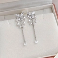Macro shot of silver butterfly tassel earrings with zircon stones and pearl chains - 24# 25285B Silver Butterfly Pearl Tassel