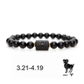 Detail of Aries zodiac elastic bracelet featuring black matte beads and golden accents - Aries