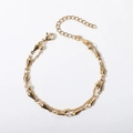 Detail of gold double-layer bracelet with metal beads and teardrop charm on white background - 17+5cm / Cross Bead Chain + Teardrop Bracelet / Gold