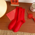 Vibrant red festive crew socks made of combed cotton on a warm wooden background - One Size / Pure Red