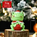 Christmas frog resin figurine wearing Santa hat and cape holding an apple ornament - Frog SD08