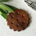 Biscuit shaped black walnut wood coaster with natural grain on white stone surface - Walnut Round Biscuit Coaster