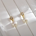 Detail of vintage gold pearl earrings with rectangle crystal on a white leather tray - Gold with Zircon