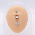 Macro shot of silver belly ring with zircon and religious pendant on a display model - Silver Religious Figure Dangle (JE0430B)