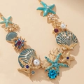 Golden starfish and seashell ocean necklace with blue rhinestones and turquoise accents - Necklace