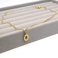 Detail of a gold stainless steel necklace with a minimalist capital O letter pendant - Letter O / Gold