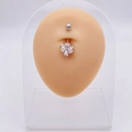 Silver flower belly ring with white zirconia stones on human silicone model - Four-leaf Clover