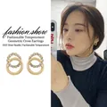 Intertwined geometric gold hoop earrings with white cubic zirconia and S925 silver needles - Round Cross Studs Gold