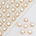 Close-up of 8mm gold-edged star beads with white pearl centers for jewelry making - Amber Gold
